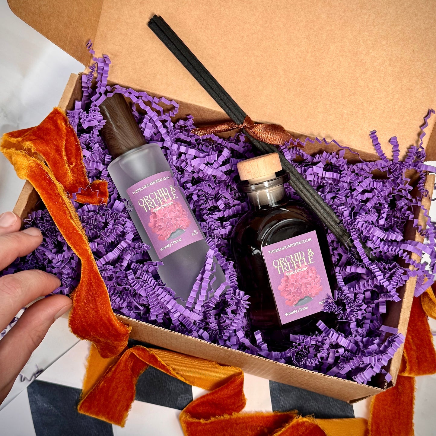 black orchid and truffle scented reed diffuser and room spray gift set contents with purple packaging