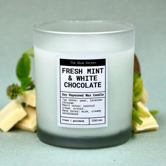 Scented soy Candle with a label reading 'Fresh Mint & White Chocolate' on a light background