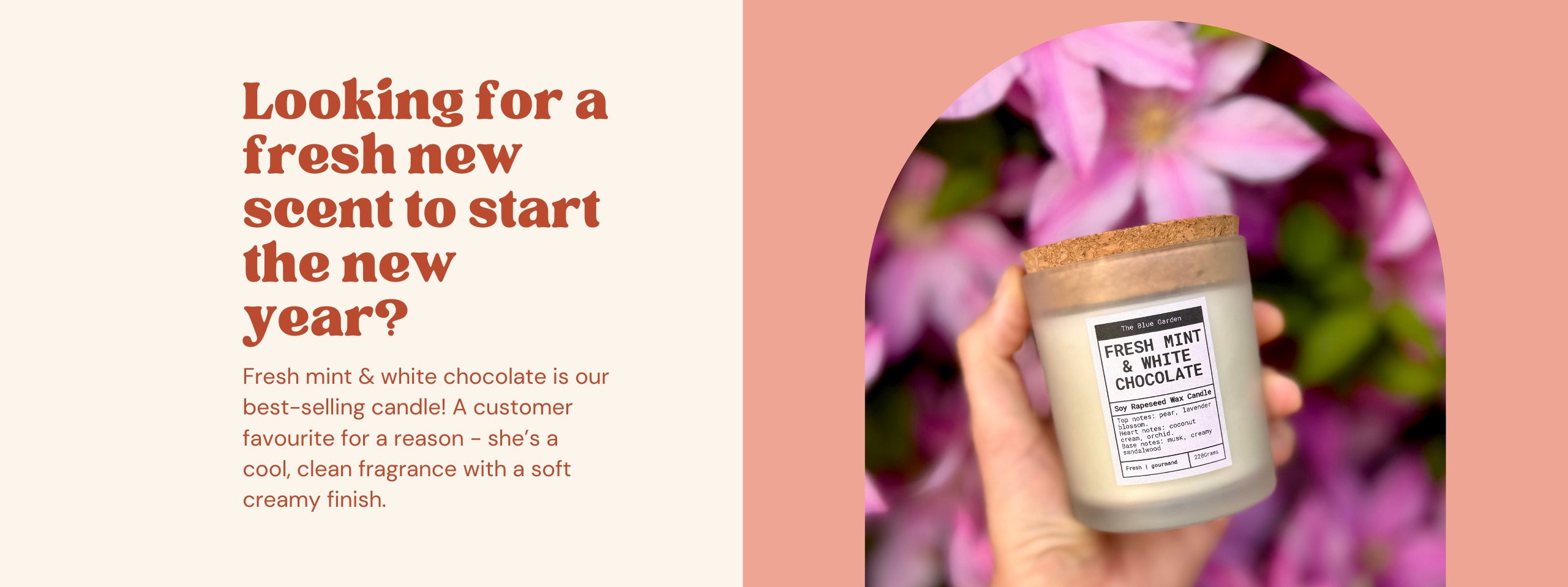 Hand holding a candle with text about a fresh scent for the new year on a pink background with flowers.