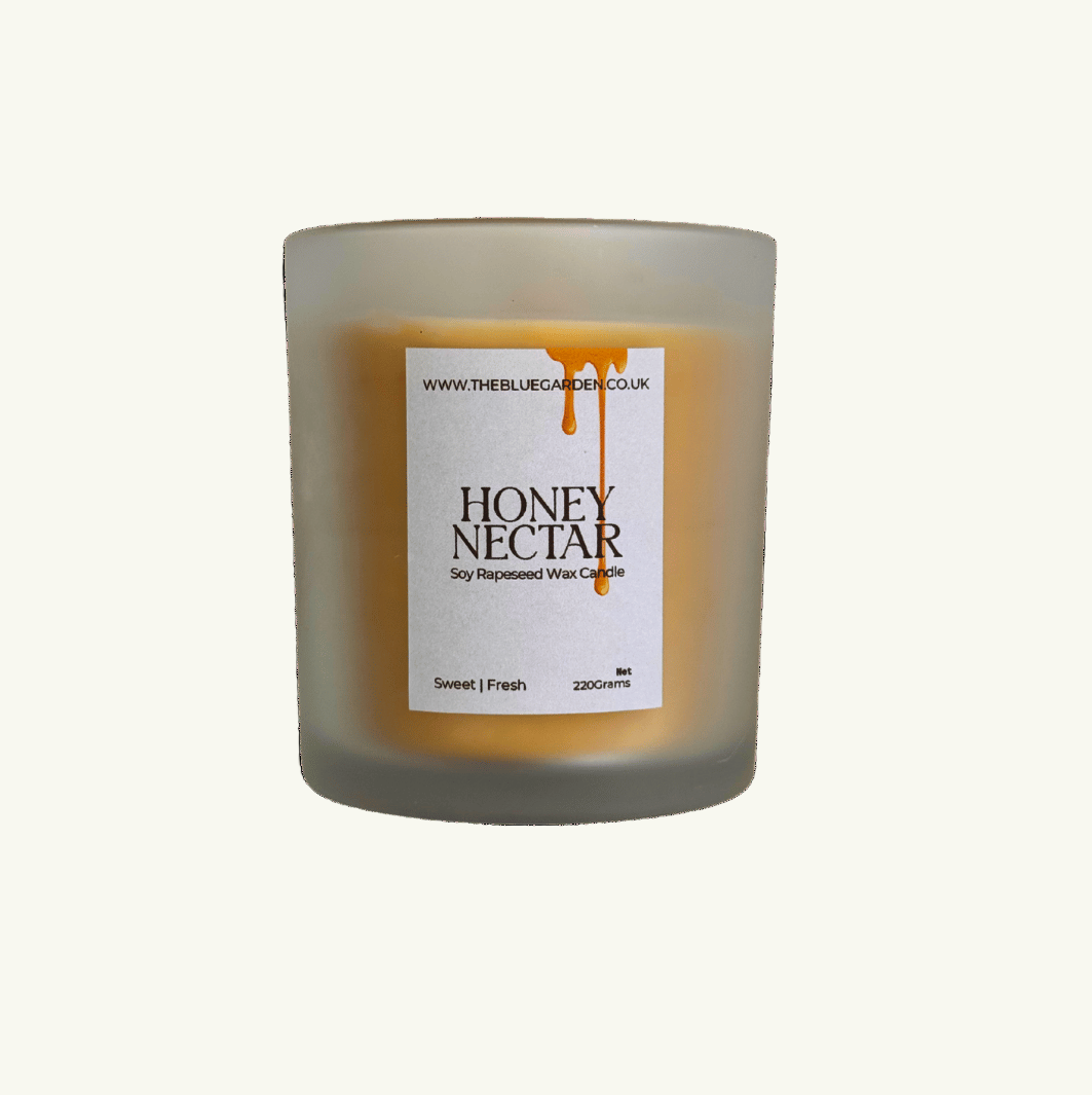 Candle labeled 'Honey Nectar' on a green background