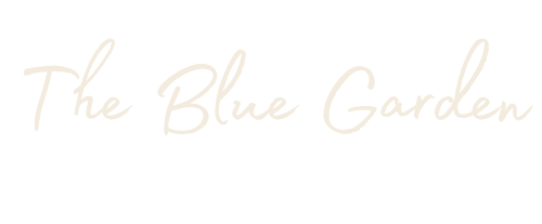 The Blue Garden logo in a light cream-colored cursive script on a solid white background.