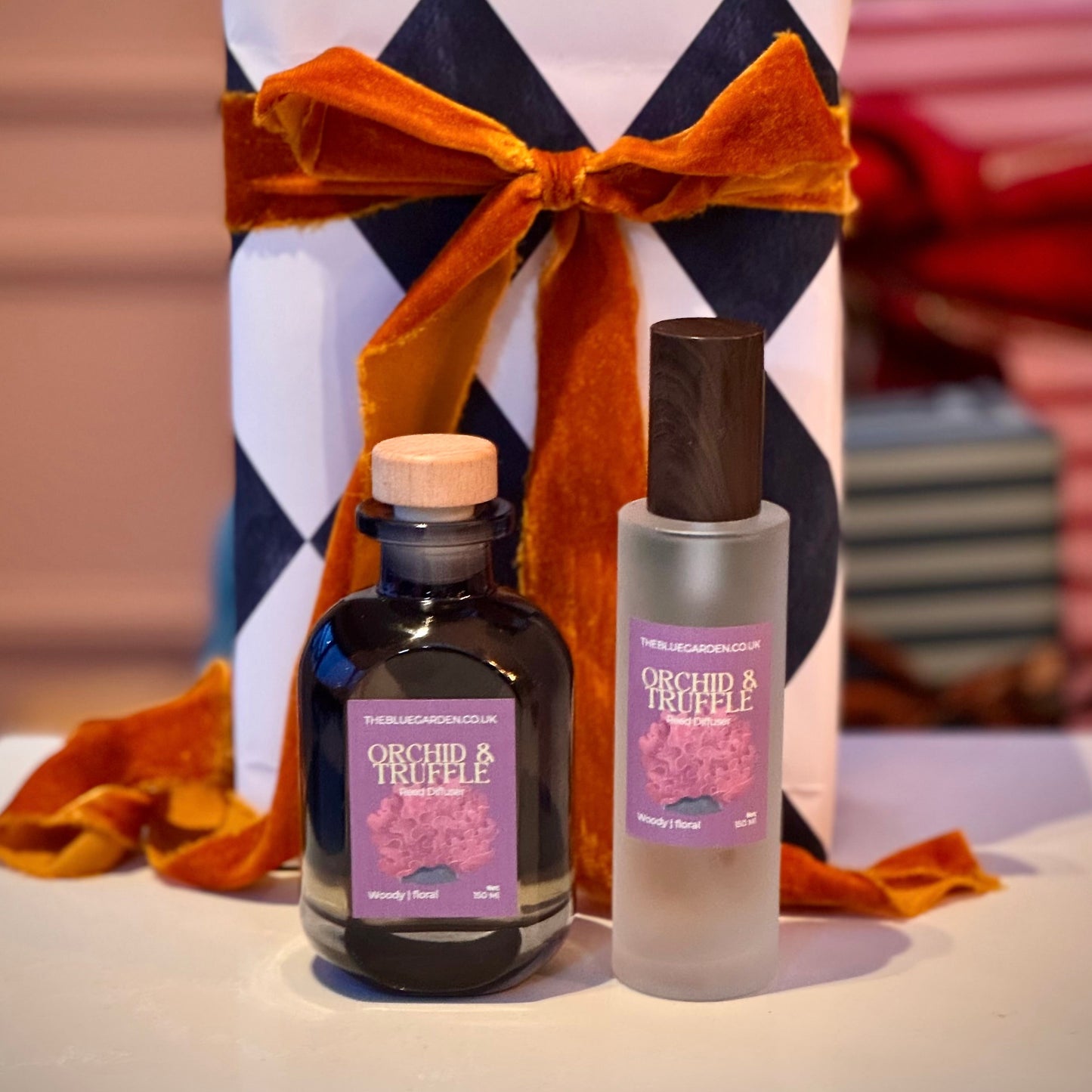 Black orchid and truffle scented reed diffuser and room spray in gift wrapped set with orange bow